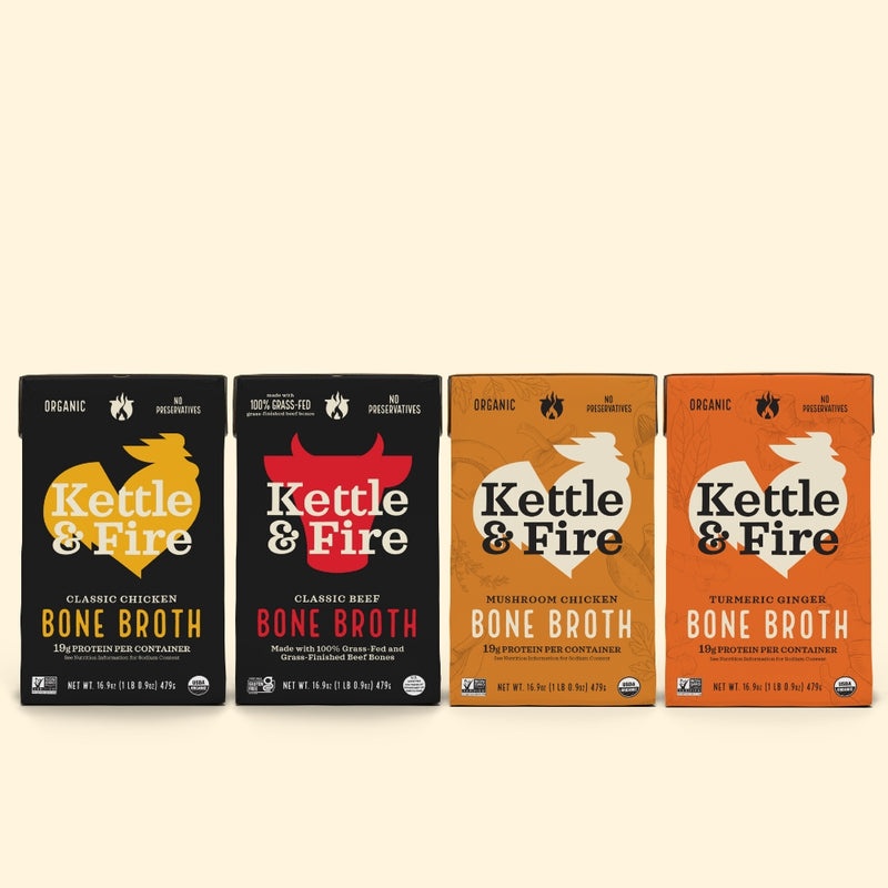 Four Kettle & Fire bone broth pouches: Classic Chicken (black), Classic Beef (black with red), Mushroom Chicken (tan), Turmer